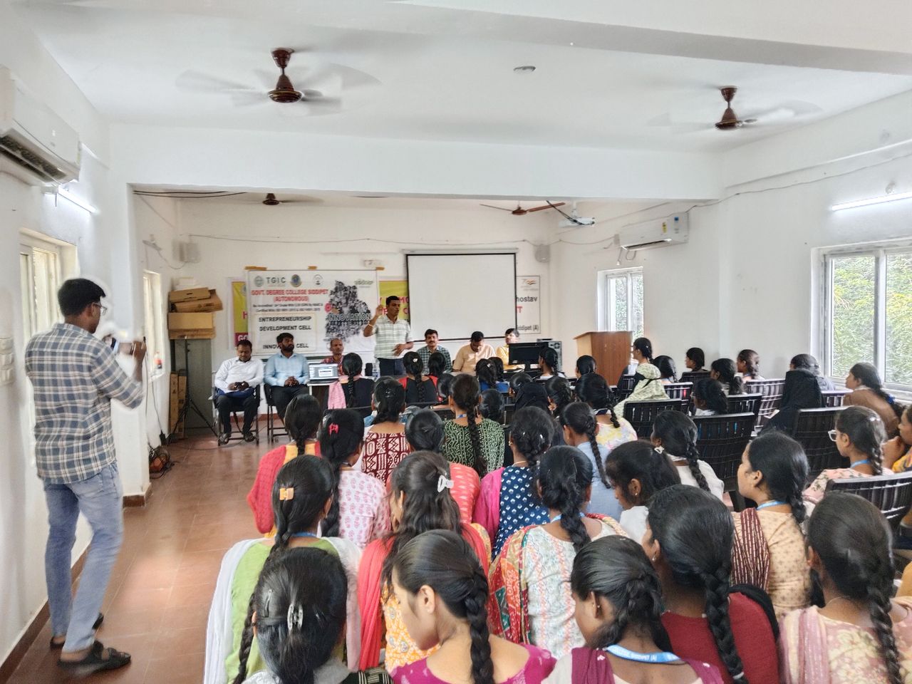 A session in a college hall with students seated facing the presenters