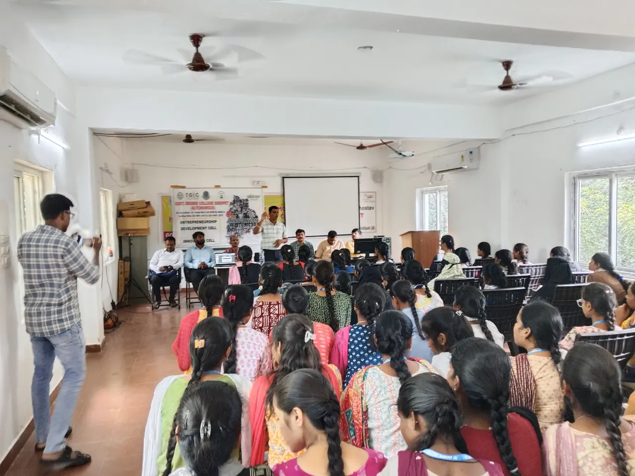 A session in a college hall with students seated facing the presenters